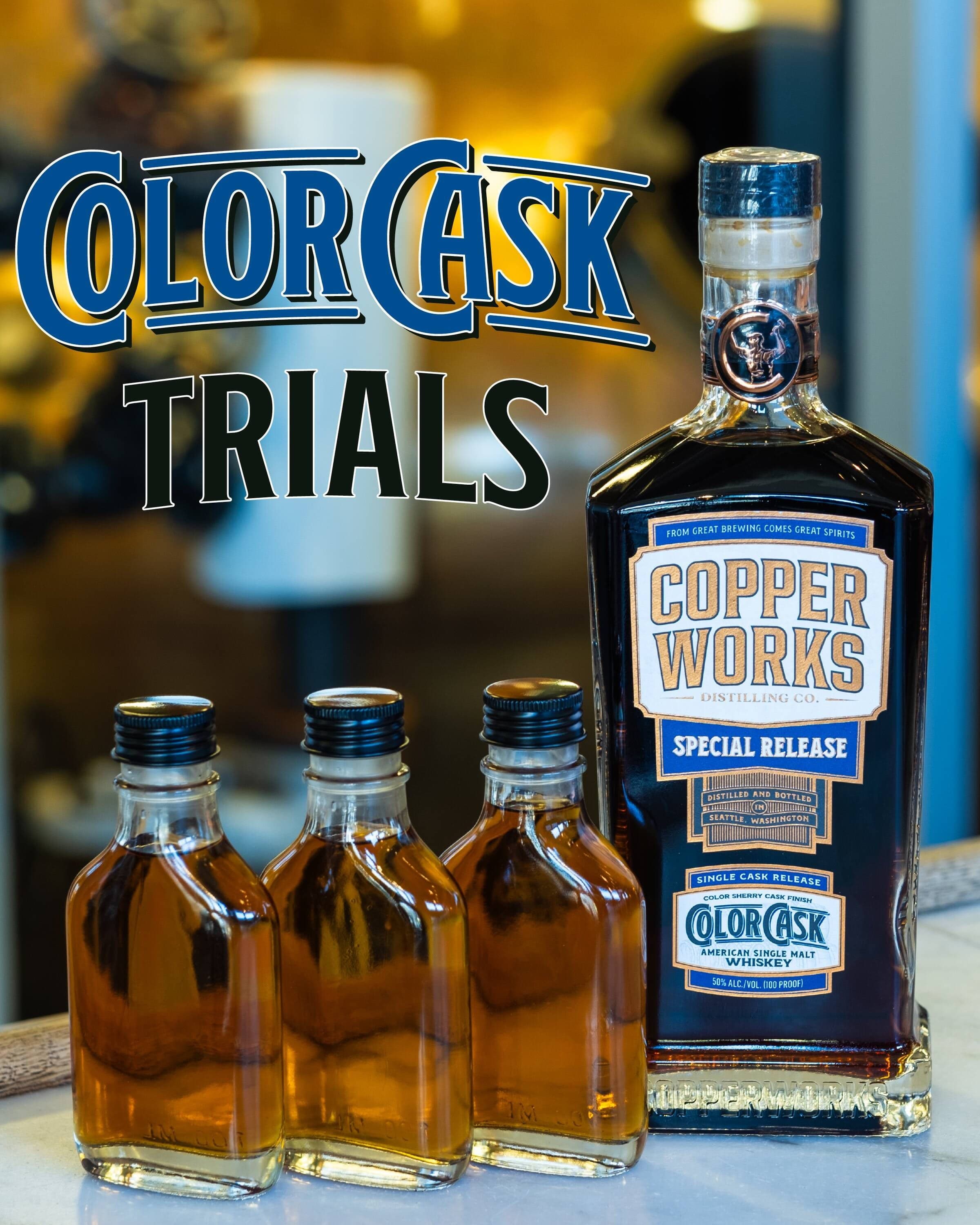 Three sample flasks of Color Cask whiskey beside a bottle of Copperworks Color Cask special release