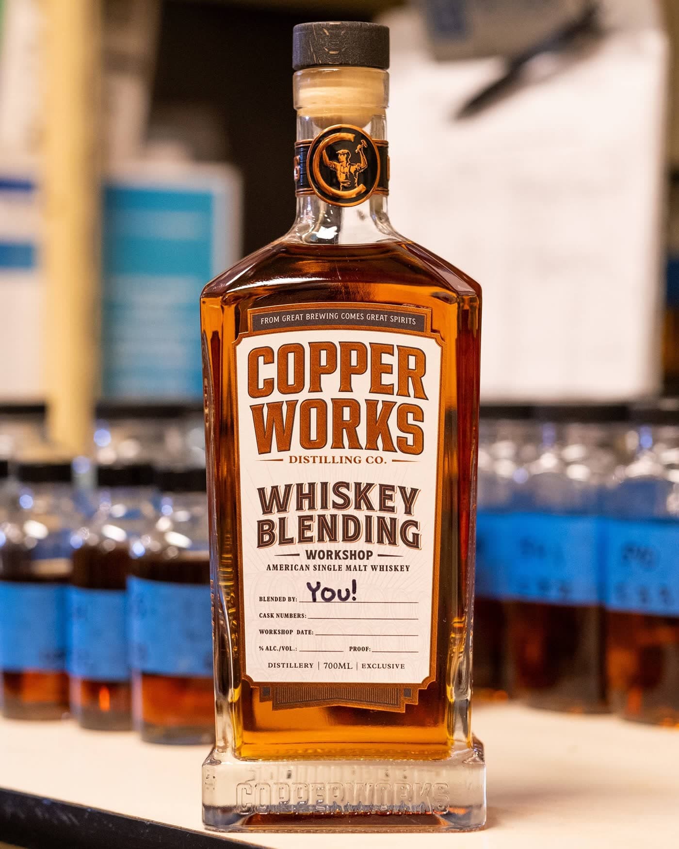 A bottle of Copperworks Whiskey Blending Workshop American Single Malt Whiskey with “You!” handwritten on the Blended By line