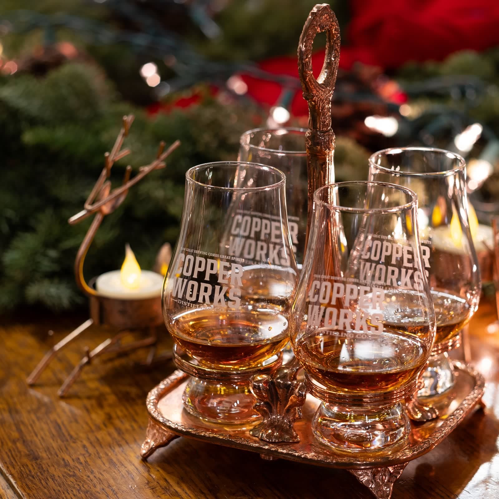 A copper tray of Copperworks Glencairn glasses poured with whiskey.