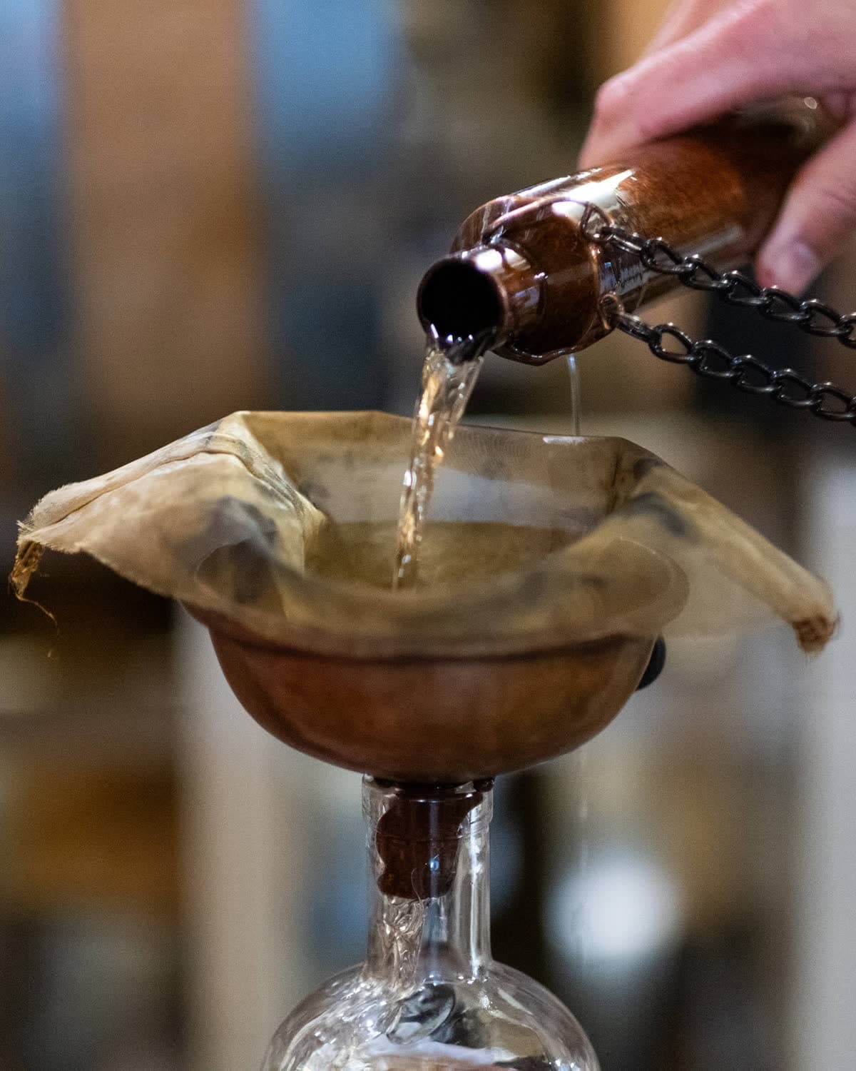 Filling a bottle straight from the cask with the copper dipping dog.